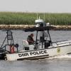 DNR Police boat with a boat in tow heading for Delaware City..